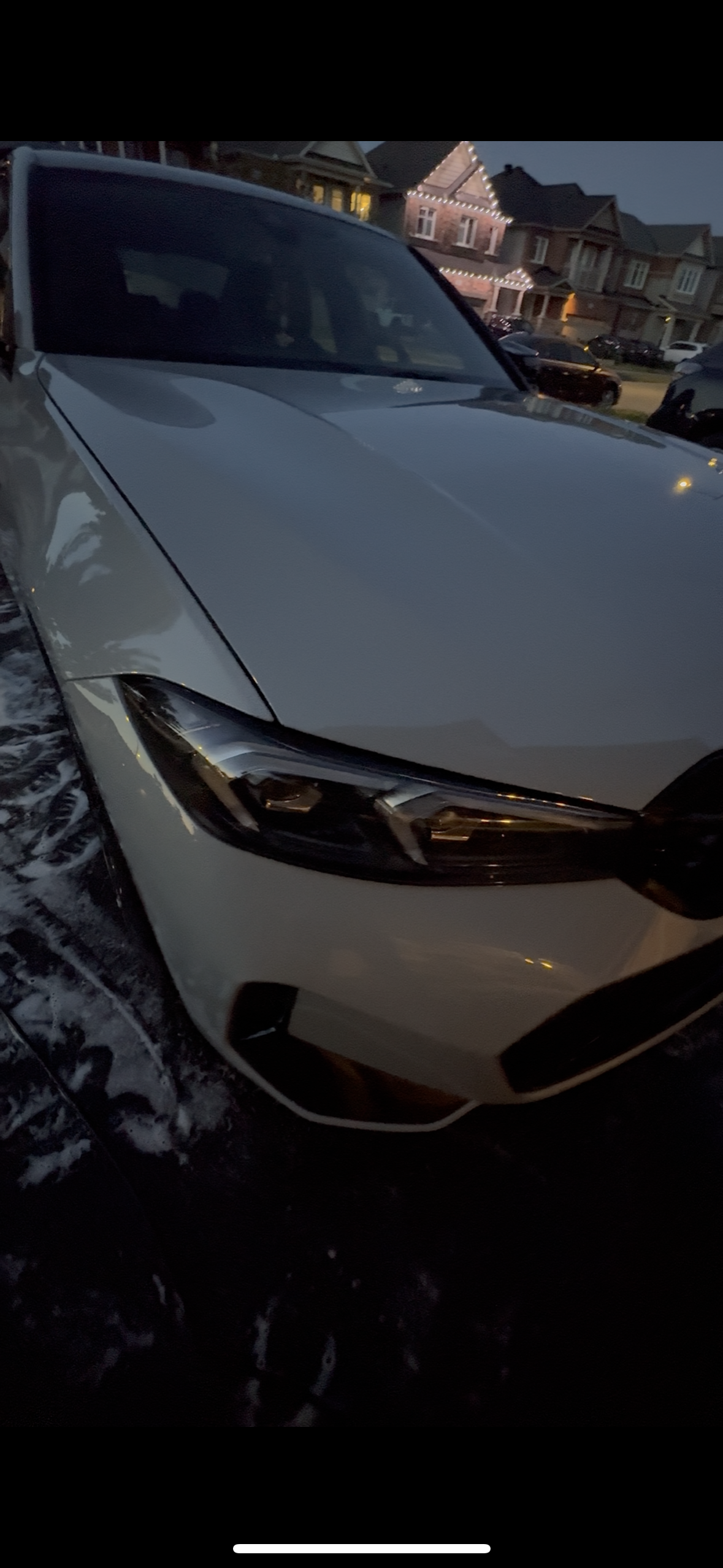 White vehicle freshly detailed in driveway at dusk