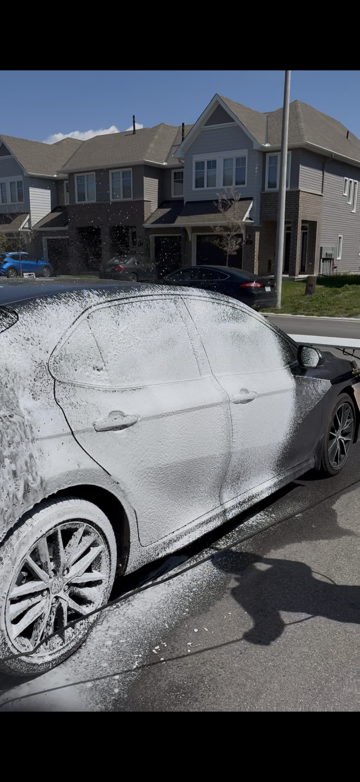 Exterior Wash — car body being washed in driveway